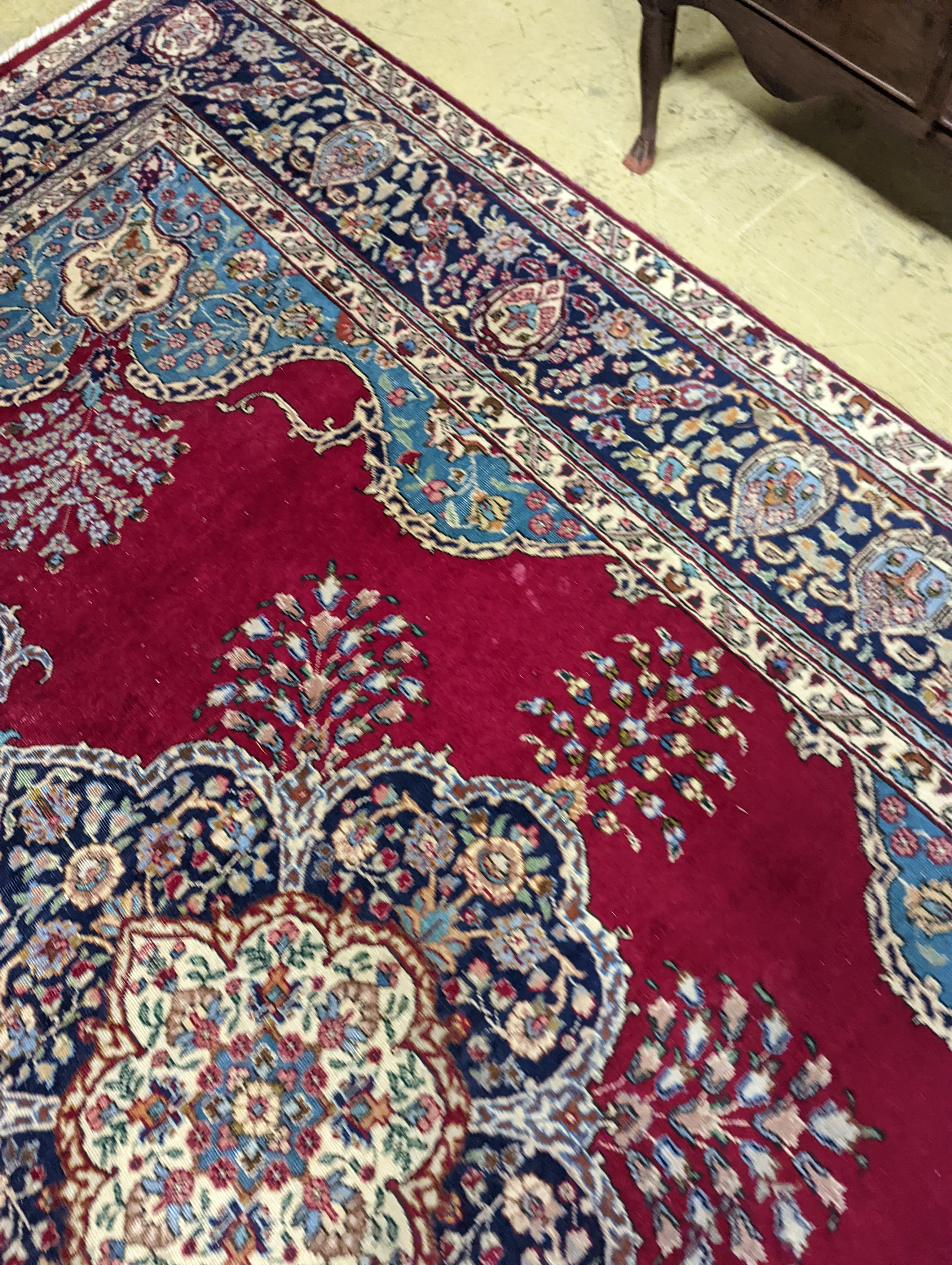 A Tabriz burgundy ground carpet, 350 x 240cm